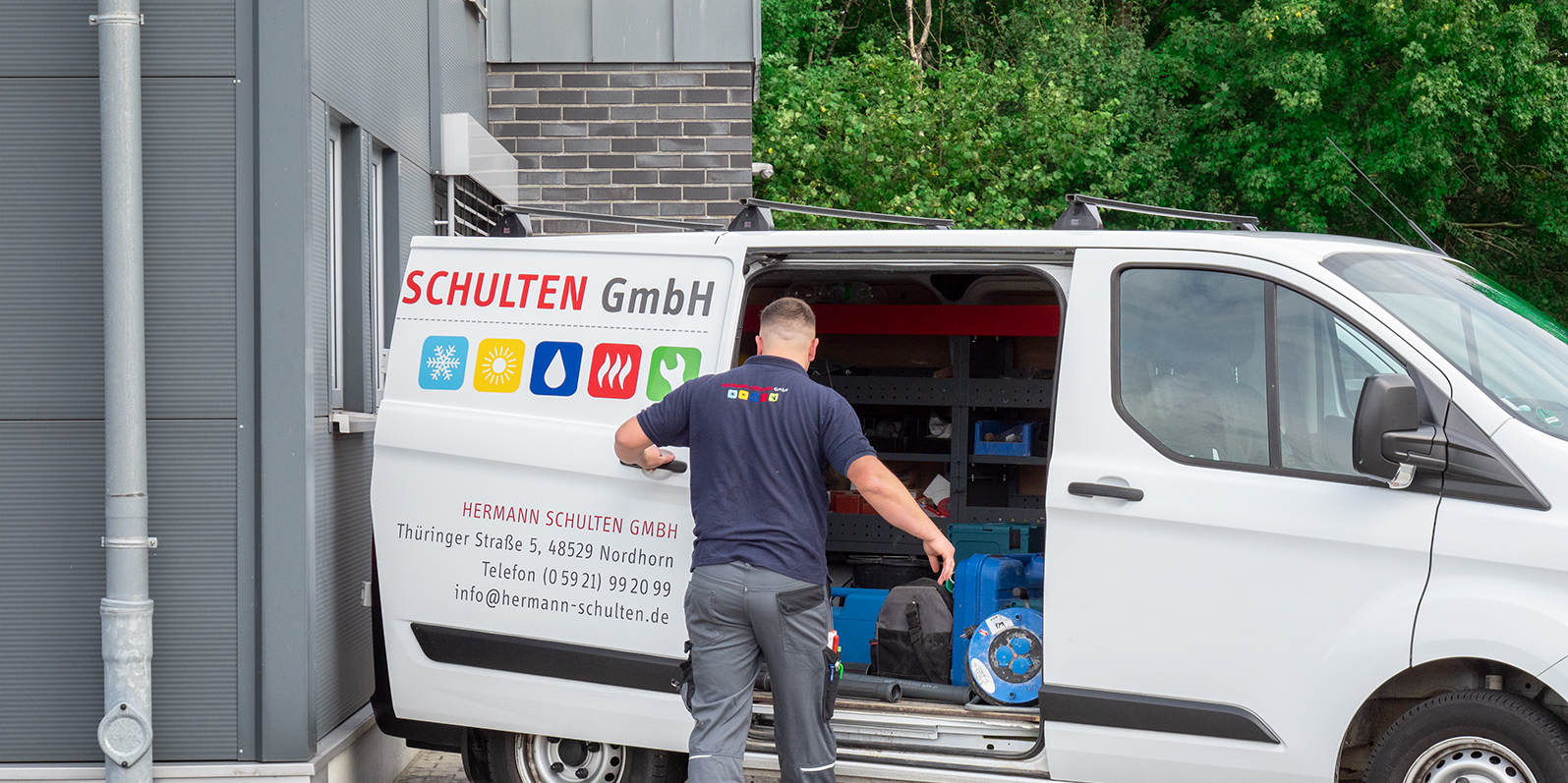 Ein Mitarbeiter der Hermann Schulten GmbH öffnet die Tür eines Transporters der Firma.